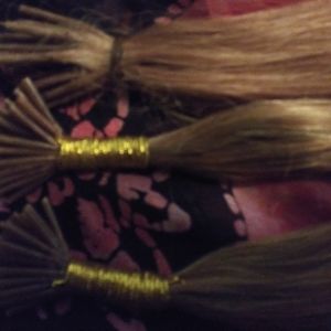 New and  Pre-owned Hair Extensions 129 strands total light golden brown.